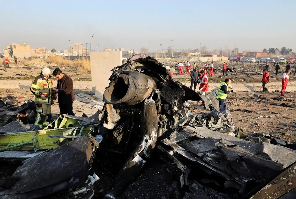 Debris is seen from an Ukrainian plane which crashed as authorities work at the scene in Shahedshahr, southwest of the capital Tehran, Iran on Jan. 8, 2020. (The Associated Press/Ebrahim Noroozi)