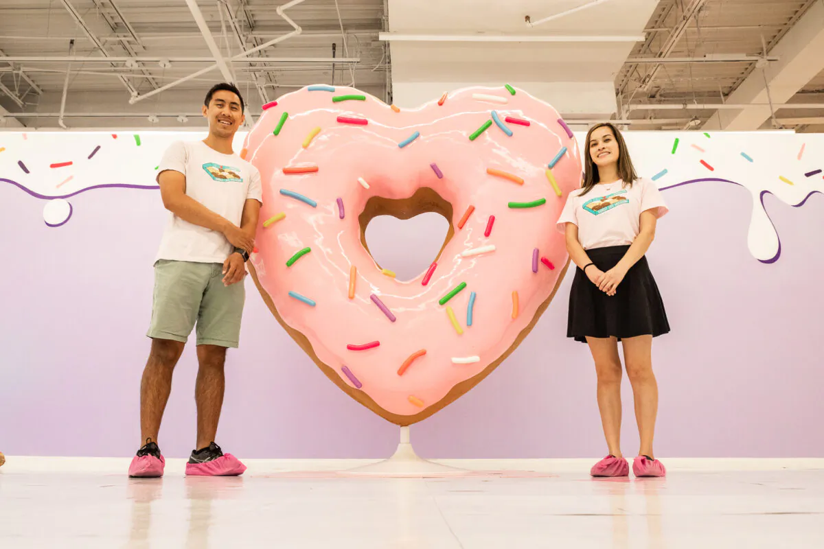 Founders Brian Ross (L) and Kathy Ly stand next to an exhibit in the Donut Life Museum in Westminster, Calif., on May 28, 2021. (John Fredricks/The Epoch Times)