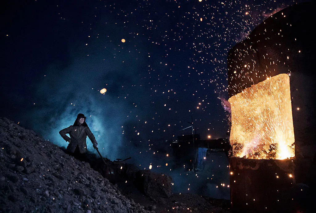 A Chinese labourer stands near a furnace as he works at an unauthorized steel factory in Inner Mongolia, China on Nov. 3, 2016. (Kevin Frayer/Getty Images)