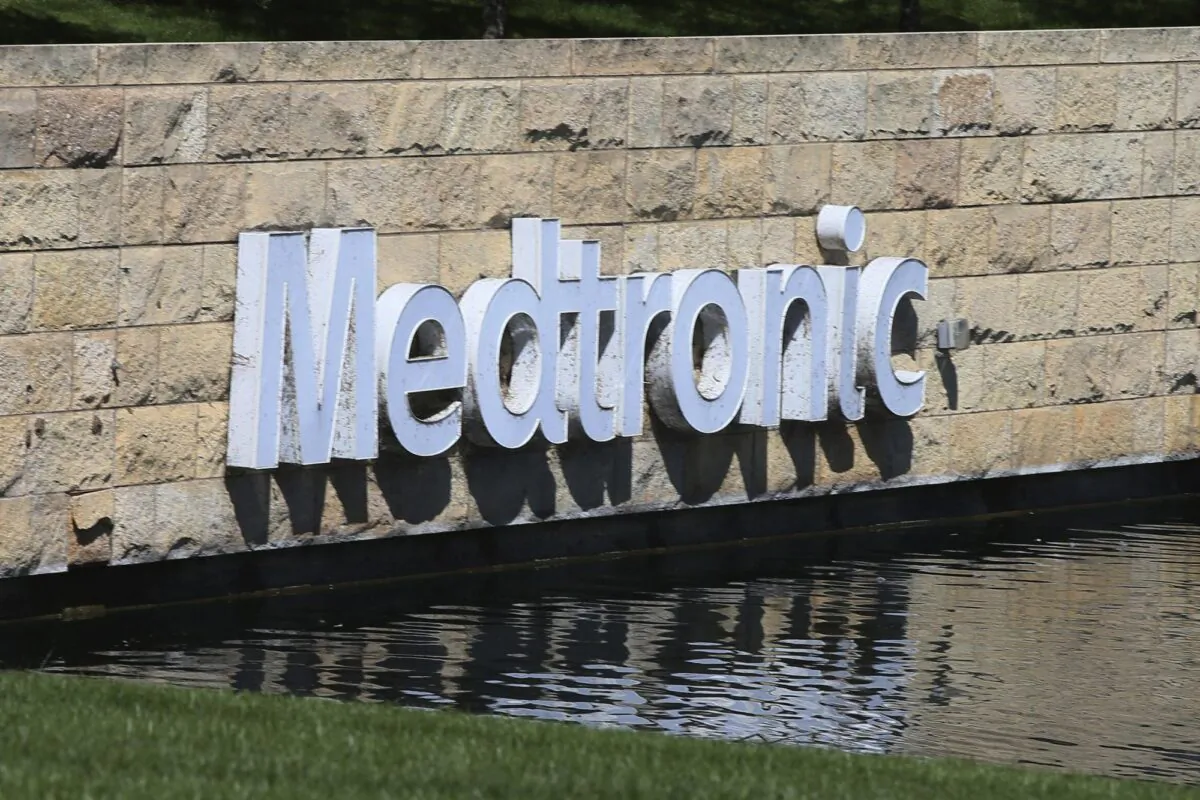 The Medronic logo is reflected in a lake at the company's offices in Fridley, Minn., on Aug. 29, 2019. (Jim Mone/AP Photo)