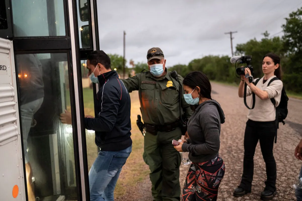 Illegal immigrants board a bus after being apprehended near the border between Mexico and the United States in Del Rio, Texas, on May 16, 2021. (Sergio Flores/AFP via Getty Images)
