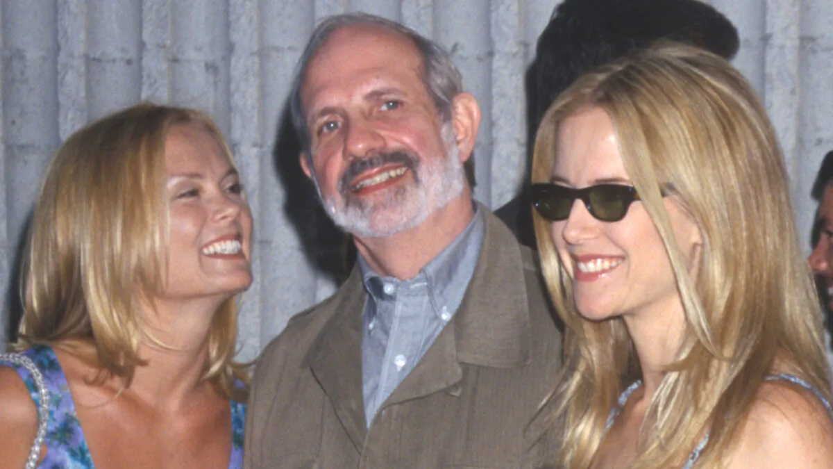 Brian De Palma (C) at the 'Six Days and Seven Nights,' premiere with Romy Walthall (L) and Kelly Preston (R), in Los Angeles, Calif., on June 8, 1998. (Kathy Hutchins/ZUMA Press/TNS)