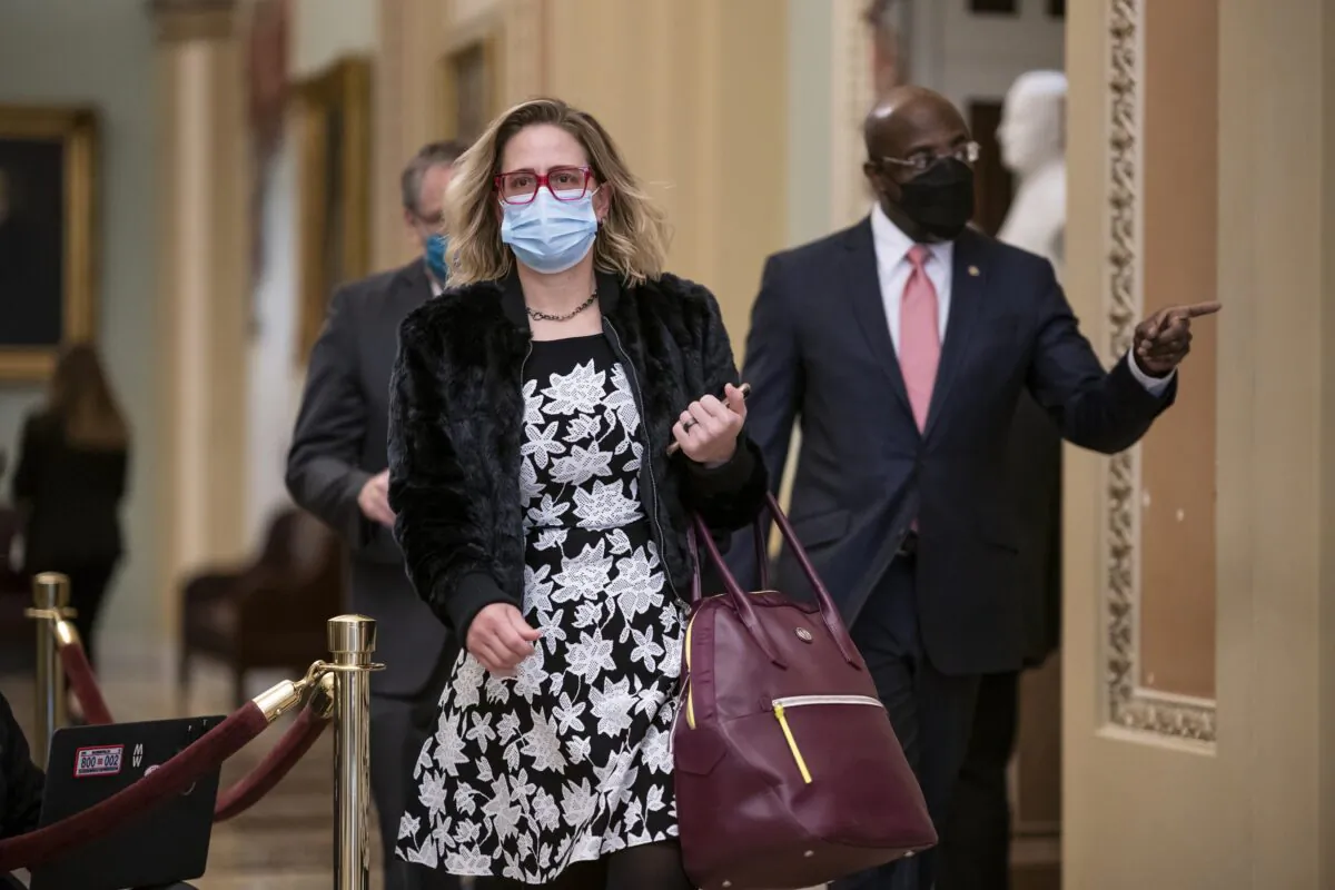 Sen. Kyrsten Sinema (D-Ariz.) arrives at the U.S. Capitol in Washington on Feb. 9, 2021. (J. Scott Applewhite/AP Photo)