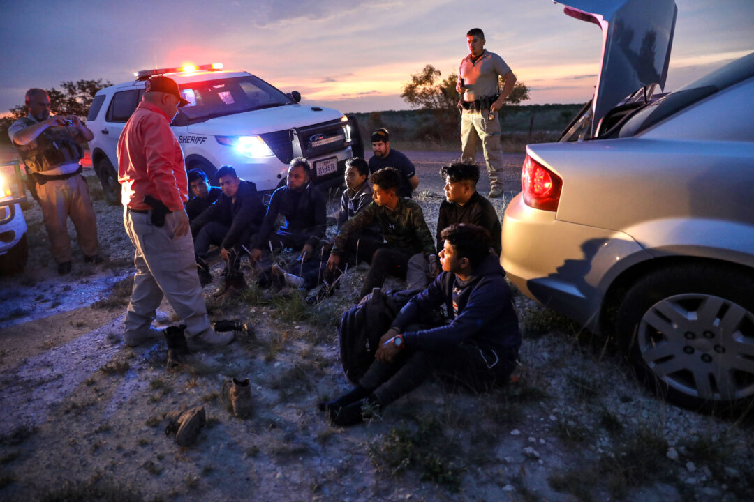 Kinney County Constable Steve Gallegos and Kinney County Sheriff’s deputies arrest a smuggler and seven illegal aliens from Guatemala near Brackettville, Texas, on May 25, 2021. (Charlotte Cuthbertson/The Epoch Times)