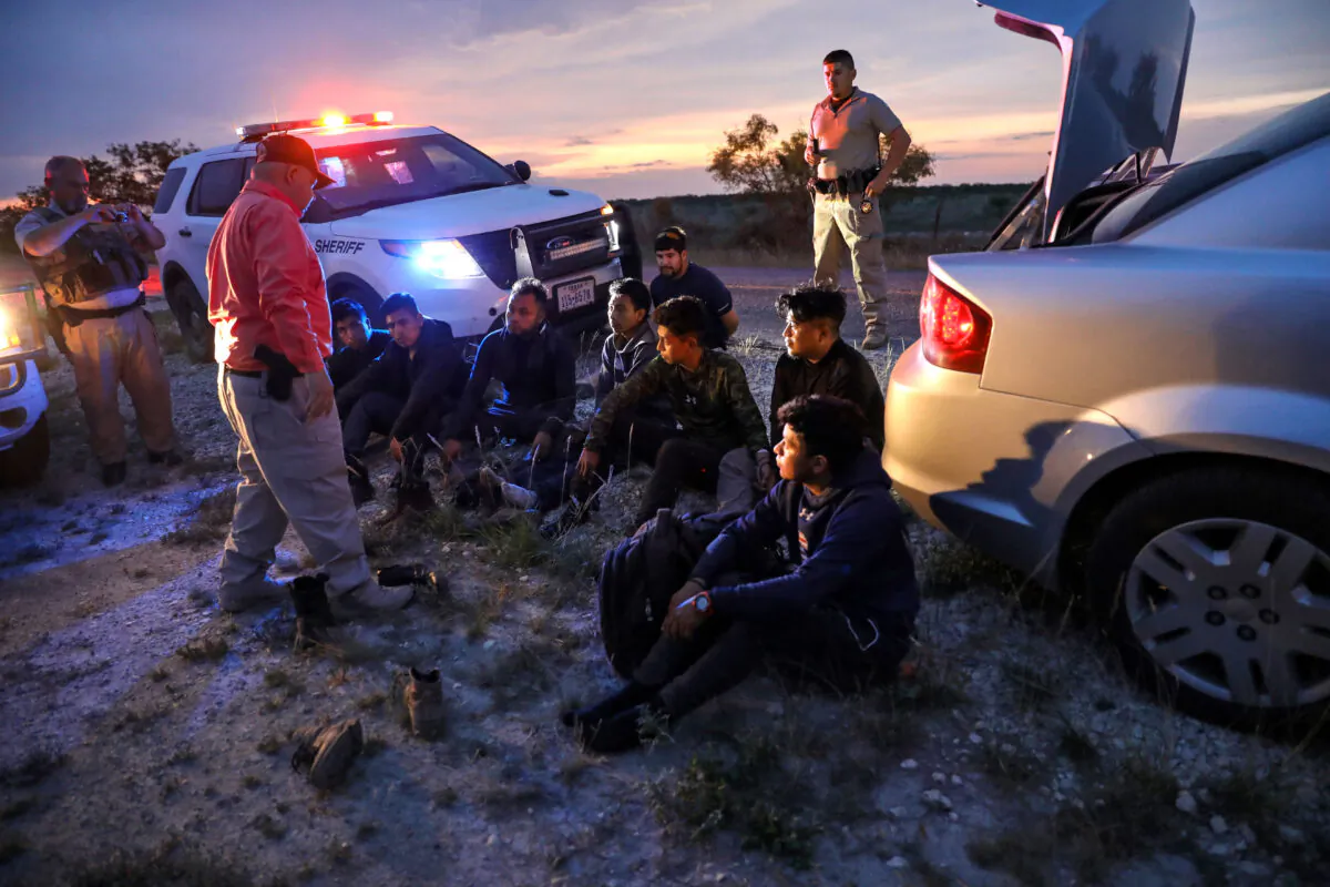 Kinney County Constable Steve Gallegos and Kinney County Sheriff’s deputies arrest a smuggler and seven illegal aliens from Guatemala near Brackettville, Texas, on May 25, 2021. (Charlotte Cuthbertson/The Epoch Times)