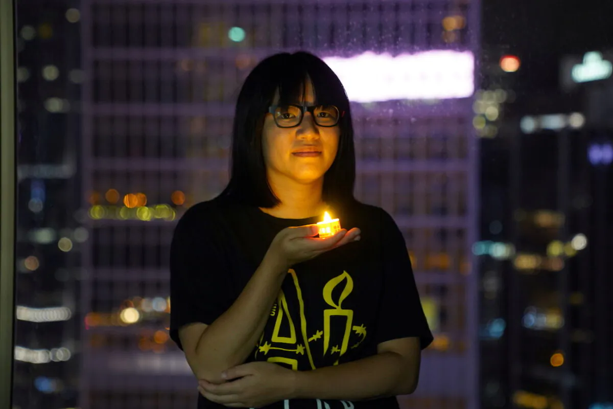 Vice-chairwoman of Hong Kong Alliance in Support of Patriotic Democratic Movements of China, Chow Hang-tung, poses with a candle ahead of the 32nd anniversary of the massacre of pro-democracy demonstrators at Beijing's Tiananmen Square in 1989, in Hong Kong, on June 3, 2021. (Lam Yik/Reuters)