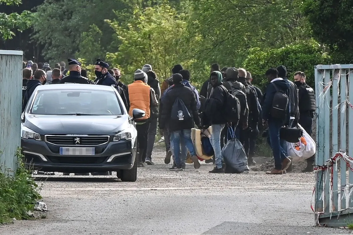Police supervise the evacuation of a migrant camp on the road to Saint-Omer near Calais, northern France, on June 4, 2021.  (Denis Charlet/AFP via Getty Images)