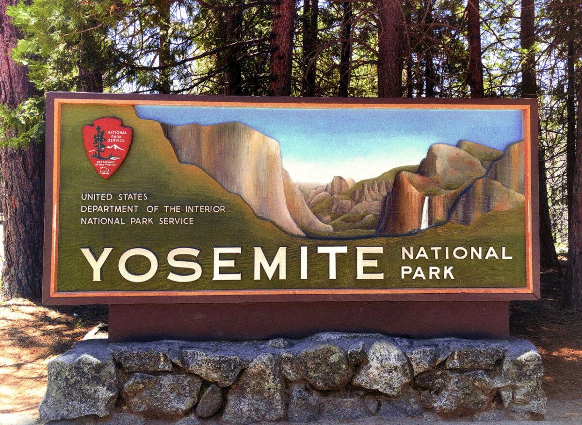 A renovated park entrance sign at the Big Oak Flat western entrance to Yosemite park.