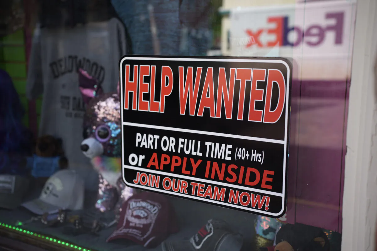A sign for workers hangs in the window of a shop along Main Street in Deadwood, S.D., on May 26, 2021. (David Zalubowski/AP Photo)