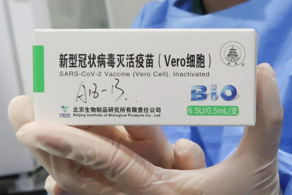 A nurse holds a box of the coronavirus disease (COVID-19) vaccine made by the Beijing Institute of Biological Products, a unit of Sinopharm subsidiary China National Biotec Group (CNBG), at a vaccination center during a government-organized visit, in Beijing, China, on April 15, 2021. (Thomas Peter/File Photo/Reuters)