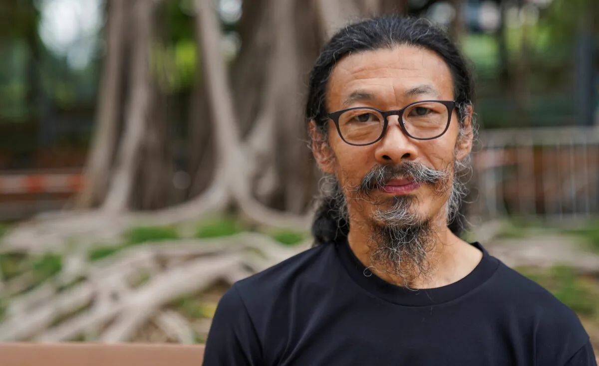 Labor rights activist and Tiananmen protester Han Dongfang poses for a picture outside Victoria Park on the 32nd anniversary of the massacre of pro-democracy demonstrators at Beijing's Tiananmen Square in 1989, in Hong Kong, on June 4, 2021. (Lam Yik/Reuters)