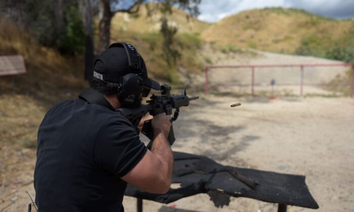 A man shoots an AR-15 style semi-automatic rifle during a demonstration at the Angeles Shooting Ranges in Pacoima, Calif., on May 20, 2019. (Augustin Paullier/AFP via Getty Images)