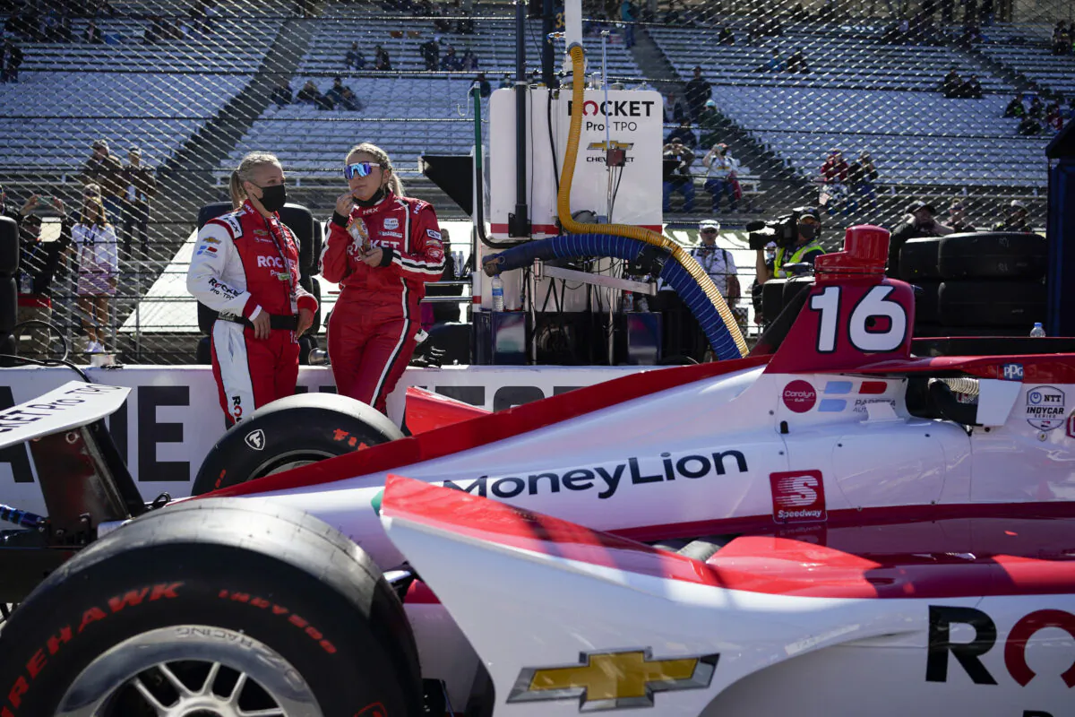 Crew members of Simona De Silvestro, the first female-majority team, stand next to their car prior to the Indianapolis 500 auto race at Indianapolis Motor Speedway in Indianapolis, Ind., on May 30, 2021. (Jeff Dean/AFP via Getty Images)