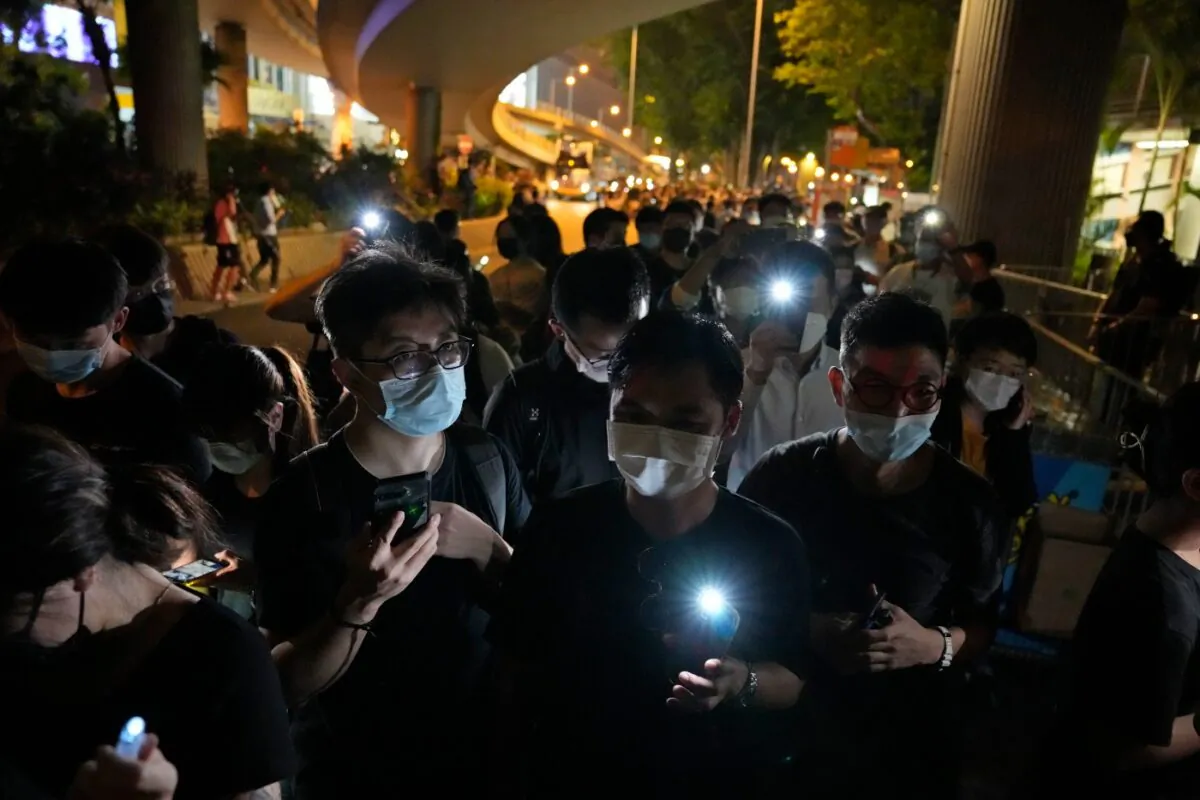 People light LED candles to mark the anniversary of the massacre of a pro-democracy student movement in Beijing, outside Victoria Park in Hong Kong, on June 4, 2021. (Kin Cheung/AP Photo)
