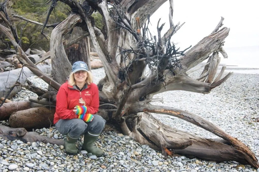 University of British Columbia forest ecology professor Suzanne Simard poses with the remains of an old cedar in Haida Gwaii, B.C., in 2017. (Jean Roach)