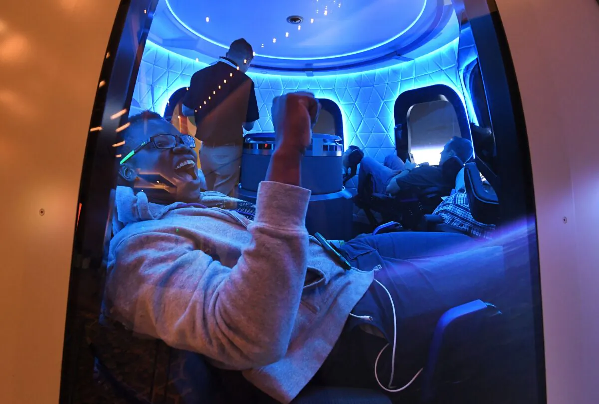 Participants enjoy the Blue Origin Space Simulator during the Amazon Re:MARS conference on robotics and artificial intelligence at the Aria Hotel in Las Vegas, Nevada on June 5, 2019. (MARK RALSTON/AFP via Getty Images)
