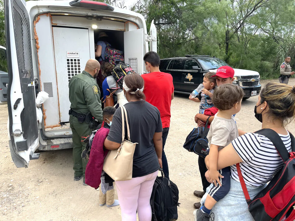 A group of Venezuelans is picked up by Border Patrol after illegally crossing the Rio Grande from Mexico into Del Rio, Texas, on June 3, 2021. (Charlotte Cuthbertson/The Epoch Times)