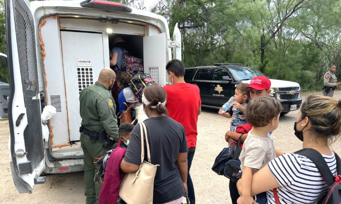 A group of Venezuelans is picked up by Border Patrol after illegally crossing the Rio Grande from Mexico into Del Rio, Texas, on June 3, 2021. (Charlotte Cuthbertson/The Epoch Times)