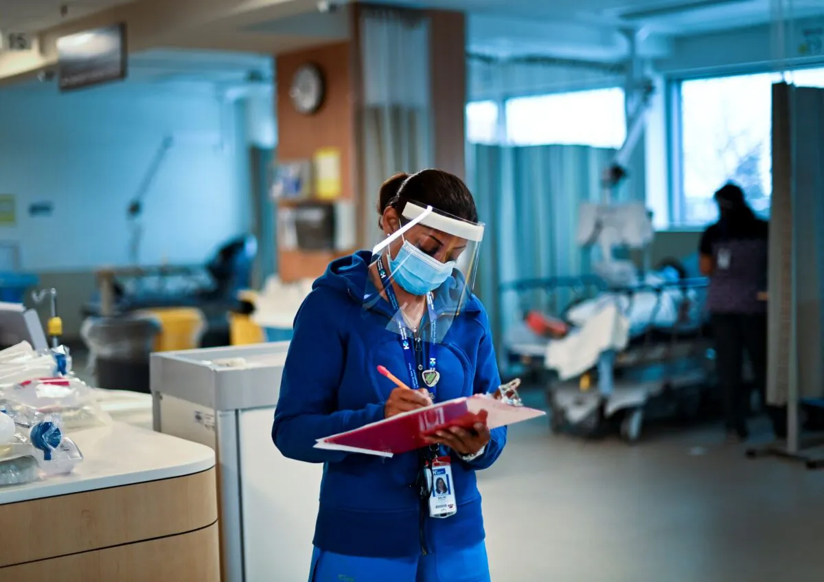 A health care worker audits different health units at a hospital in Toronto on Dec. 9, 2020. (Nathan Denette/The Canadian Press)