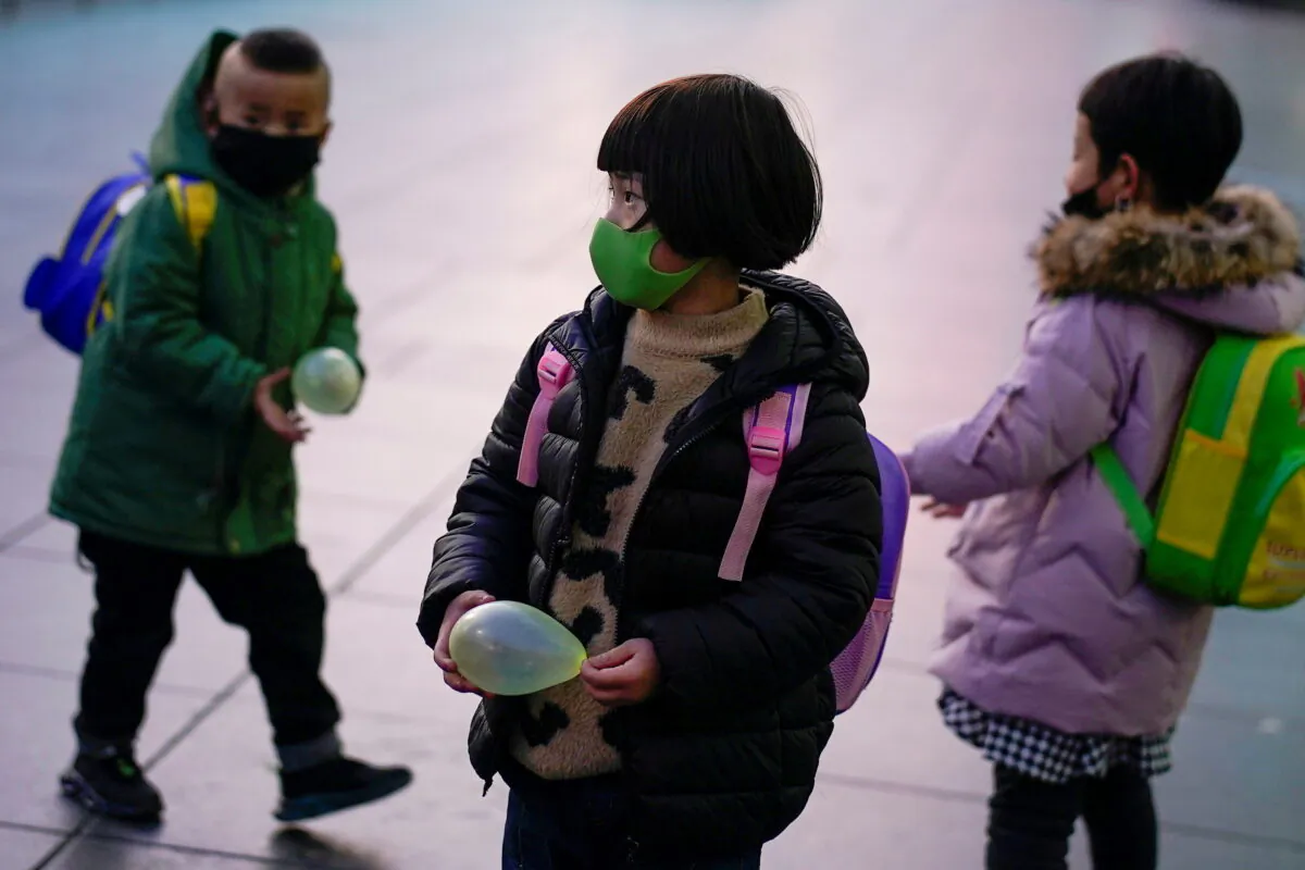 Children are seen at Shanghai railway station in Shanghai, China, on March 5, 2020. (Aly Song/Reuters)