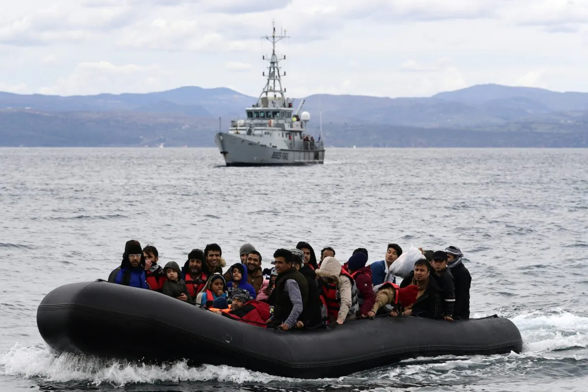 Illegal immigrants arrive in a dinghy accompanied by Frontex vessels at the village of Skala Sikaminias, on the Greek island of Lesbos, after crossing the Aegean Sea from Turkey, on Feb. 28, 2020. (Michael Varaklas/AP Photo)