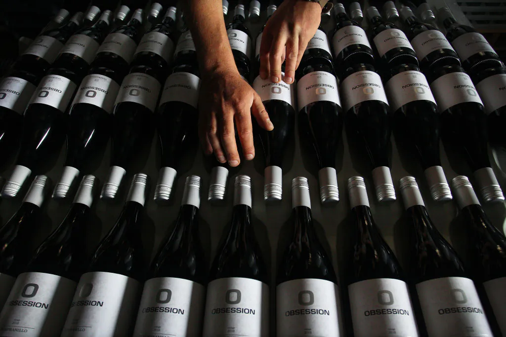 A man handles wine stock in the processing building at Obsession Wines on Nov. 24, 2020, in Tumbarumba, Australia. (Lisa Maree Williams/Getty Images)