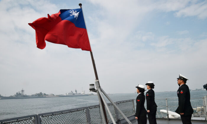 Taiwanese sailors salute the island's flag on the deck of the Panshih supply ship after taking part in annual drills at the Tsoying naval base in Kaohsiung, Taiwan, on Jan. 31, 2018. (Mandy Cheng/AFP via Getty Images)