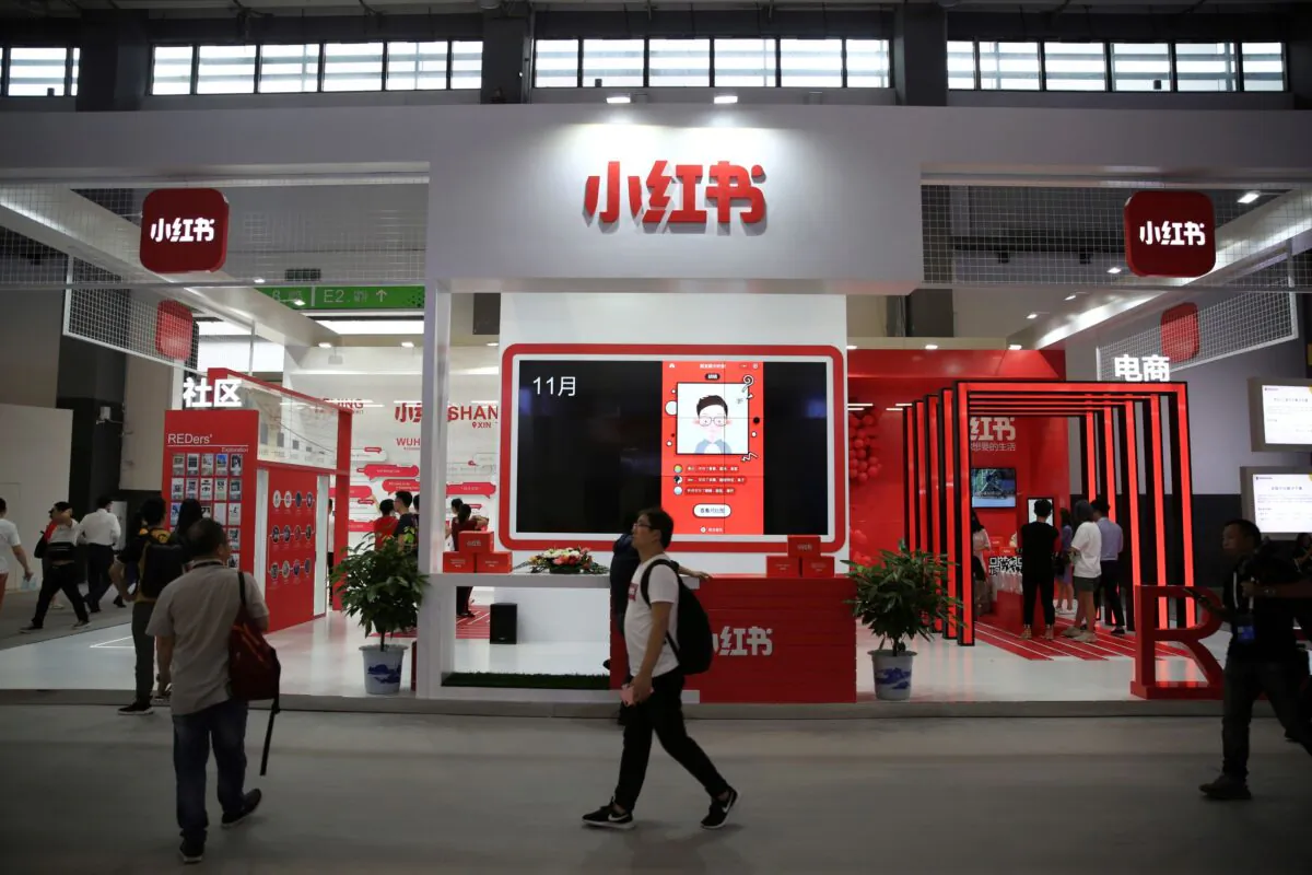 A man walks past the booth of Chinese startup Xiaohongshu at the Big Data Expo in Guiyang, Guizhou province, China, on May 27, 2019. (Stringer/Reuters)