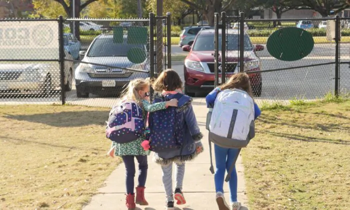 School children wearing masks walk outside Condit Elementary School in Bellaire, outside Houston, Texas, on Dec. 16, 2020. (Francois Picard/AFP via Getty Images)