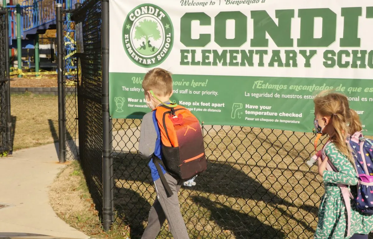 School children wearing masks walk outside Condit Elementary School in Bellaire, outside Houston, Texas, on Dec. 16, 2020. (Francois Picard/AFP via Getty Images)