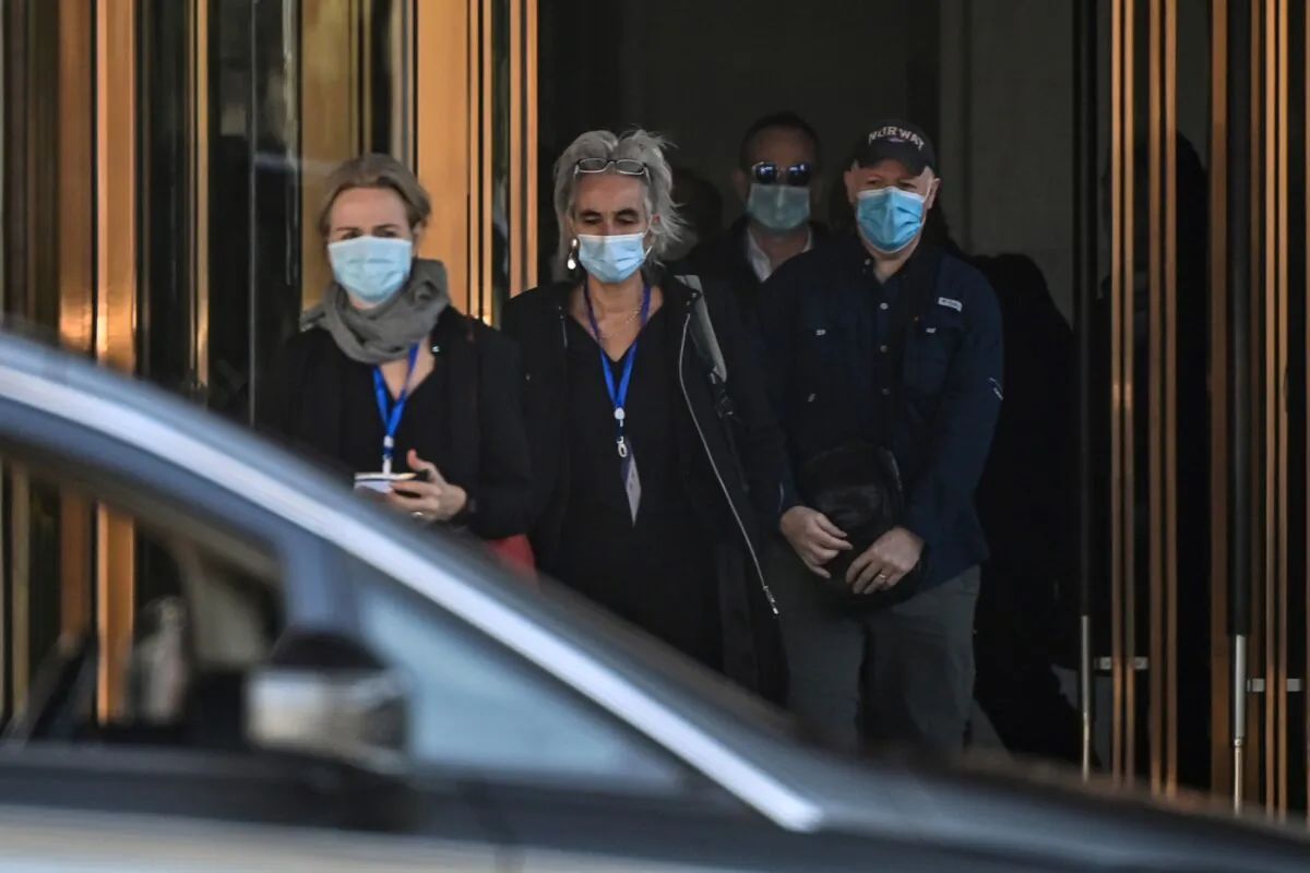 (L-R) Thea Fischer, Marion Koopmans, Peter Daszak and other members of the World Health Organization (WHO) team investigating the origins of the Covid-19 pandemic, leave the Hilton Wuhan Optics Valley Hotel in Wuhan, on Jan. 29, 2021. (HECTOR RETAMAL/AFP via Getty Images)