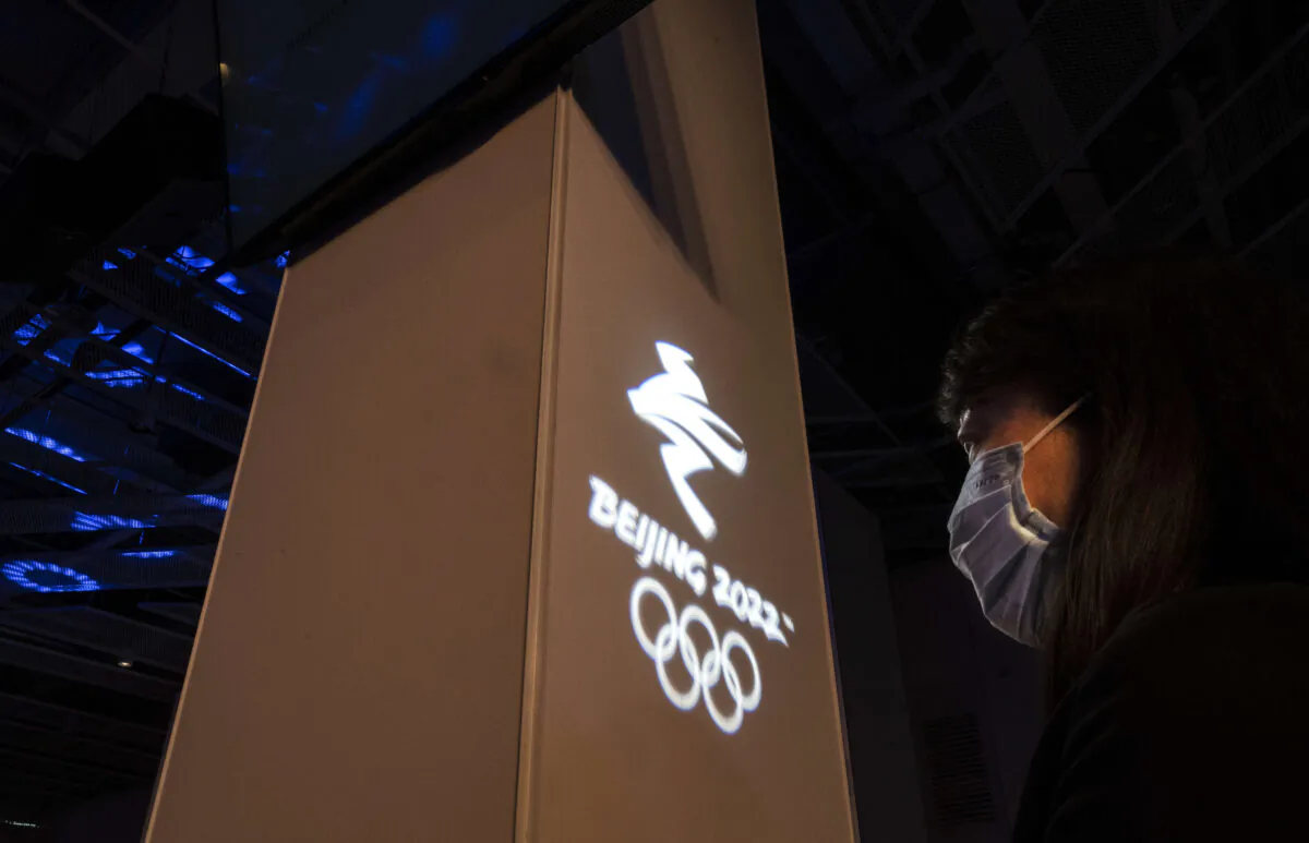 A woman at an event held by the organizing committee of the Beijing 2022 Winter Olympics for international media at their headquarters at Shougang in Beijing, China, on April 12, 2021. (Kevin Frayer/Getty Images)