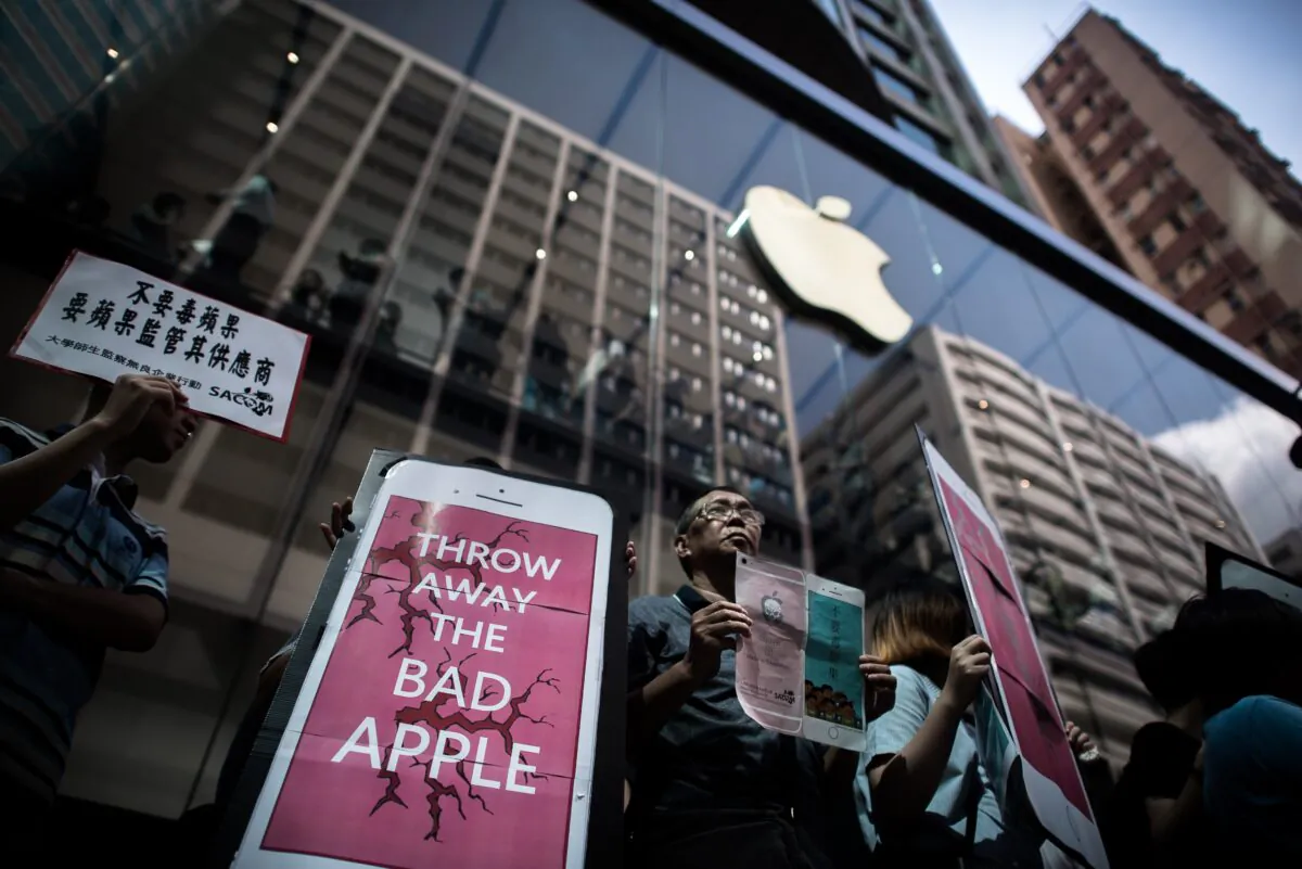 Rights campaigners stage a protest coinciding with the launch of the new iPhone 6s outside an Apple store in Hong Kong on Sept. 25, 2015.  Apple was urged to act as rights campaigners said a Chinese touchscreen glass supplier to the smartphone giant was exploiting factory workers. (Philippe Lopez/AFP via Getty Images)