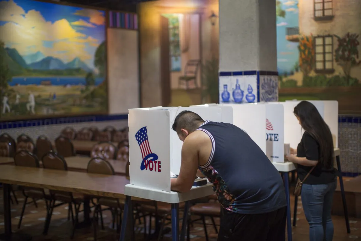 Latinos vote at a polling station in El Gallo Restaurant in Los Angeles, Calif., on Nov. 8, 2016. (David McNew/Getty Images)