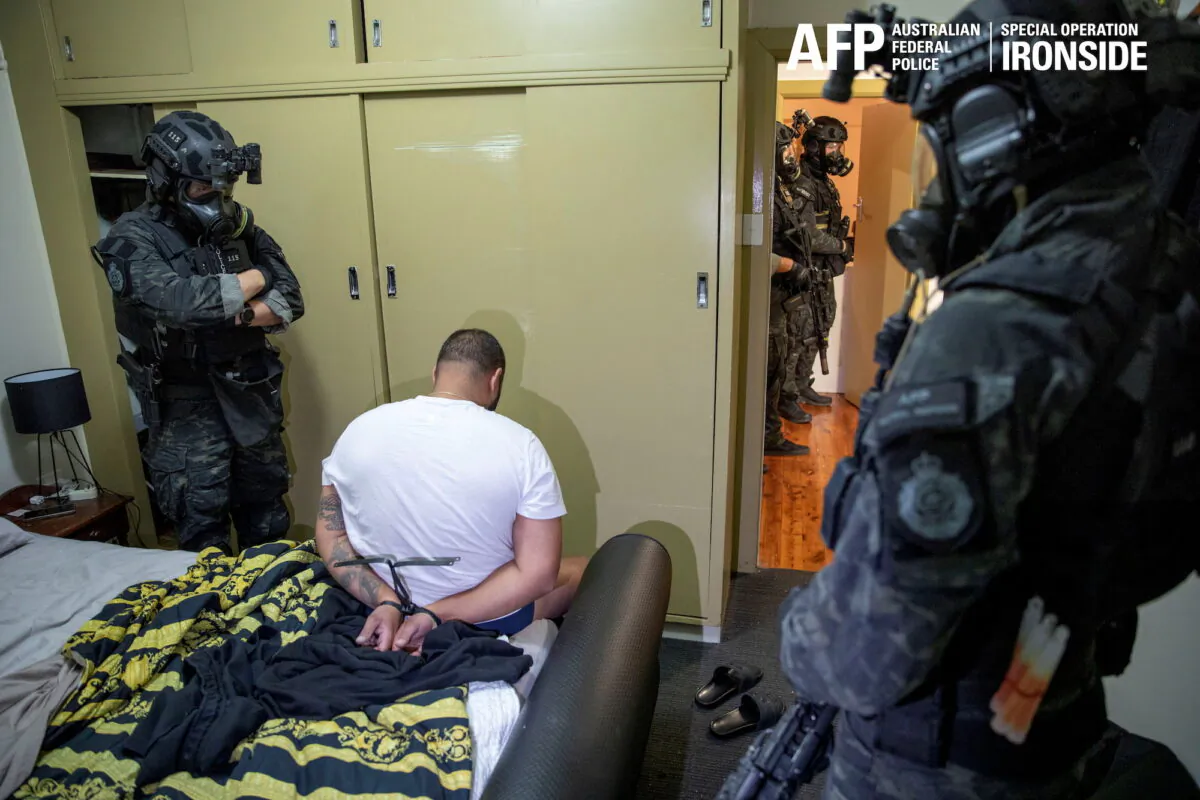A suspect is detained by Australian police in a sting against organized crime in this undated handout photo released on June 8, 2021. (Australian Federal Police/Handout via Reuters)