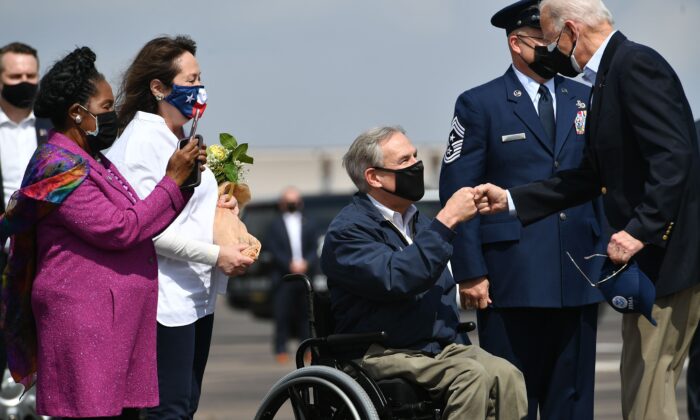 President Joe Biden (R) greets Texas Governor Greg Abbott and his wife Cecilia Abbott (2nd L) at Ellington Field Joint Reserve Base in Houston, Texas, on Feb. 26, 2021. Also welcoming the president is Rep. Sheila Jackson Lee (L). (Mandel Ngan/AFP via Getty Images)