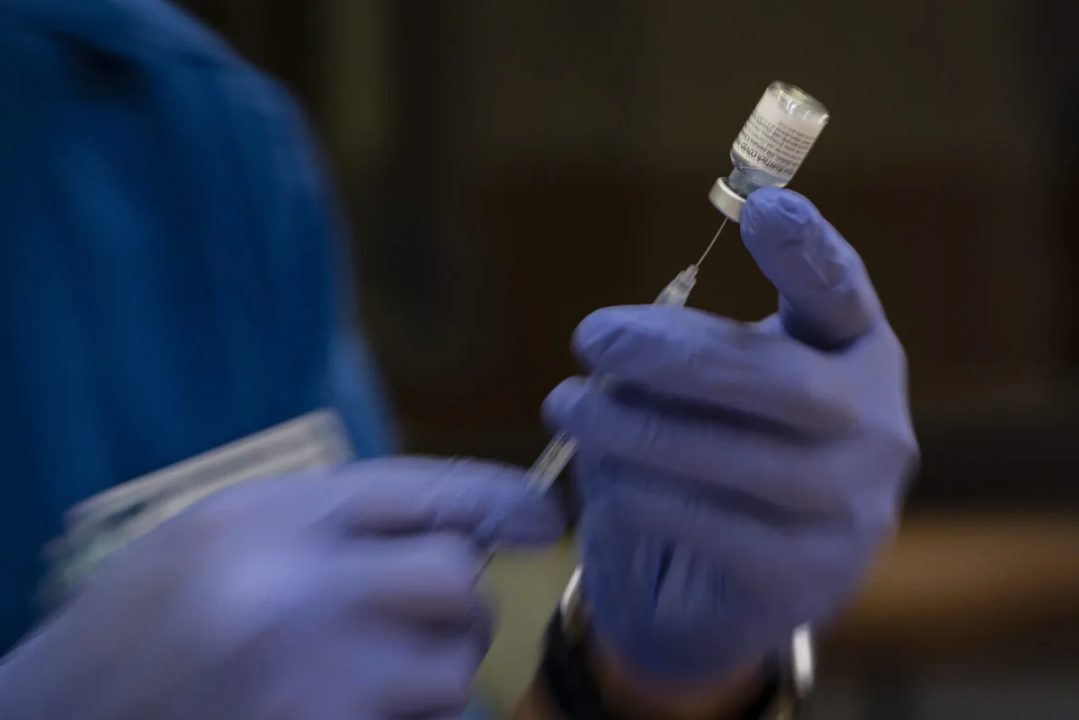 A nursing student prepares doses of the Pfizer COVID-19 vaccine for use in a vaccination clinic hosted by Odessa College in Odessa, Texas, on June 3, 2021. (Eli Hartman/Odessa American via AP)