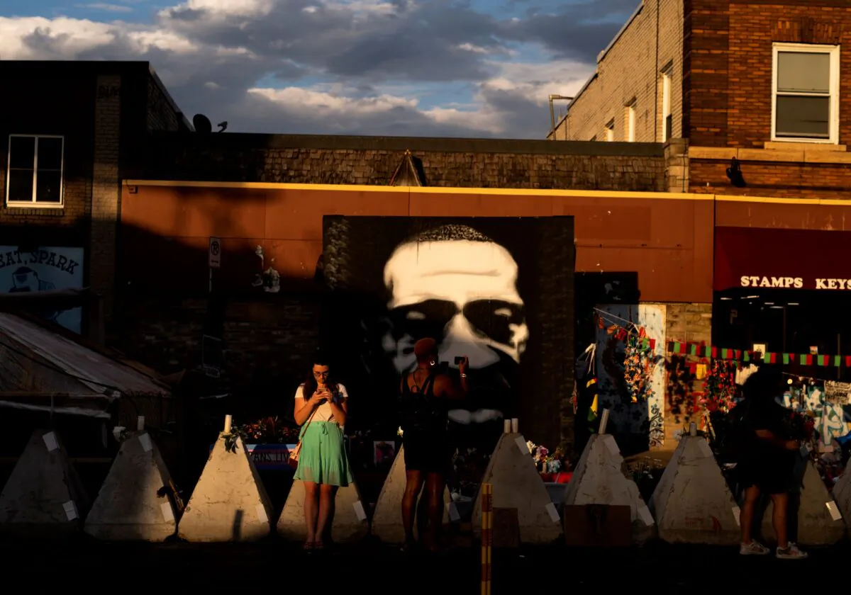 People look on a portrait of George Floyd at George Floyd Square in Minneapolis, Minn., on June 3, 2021. (Stephen Maturen/Getty Images)