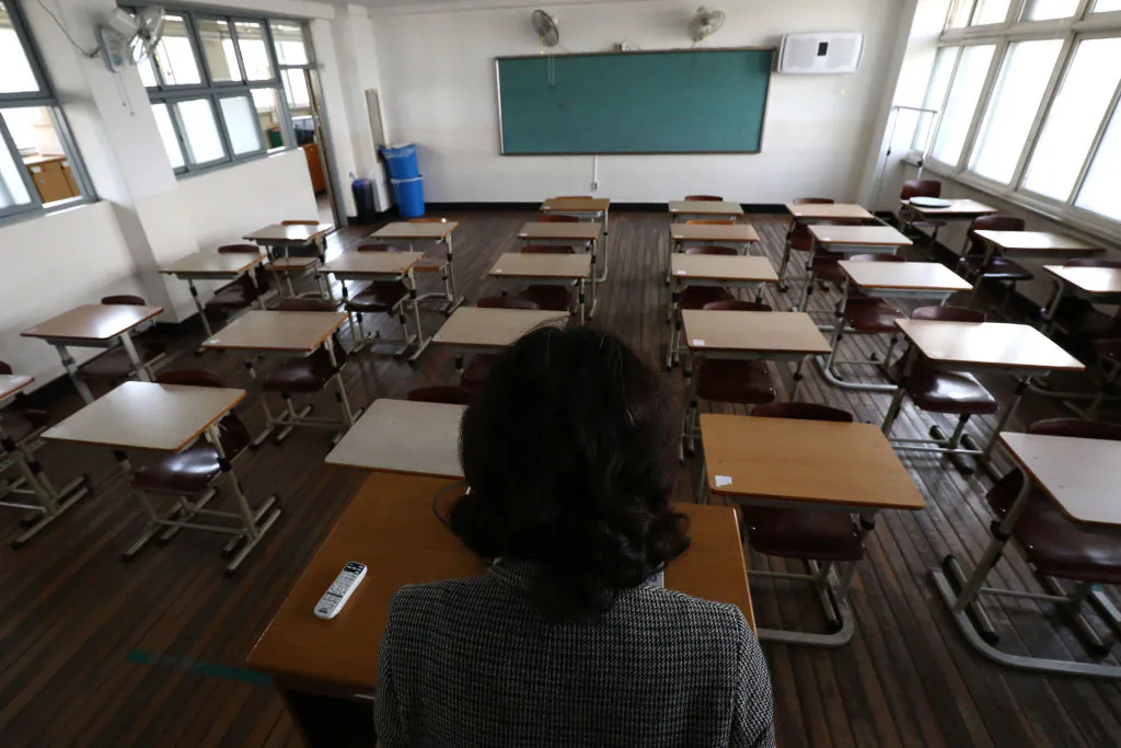 A teacher gives a lesson on the first day of online class in an empty classroom at Seoul Girls High School on April 9, 2020, in Seoul, South Korea. (Chung Sung-Jun/Getty Images)