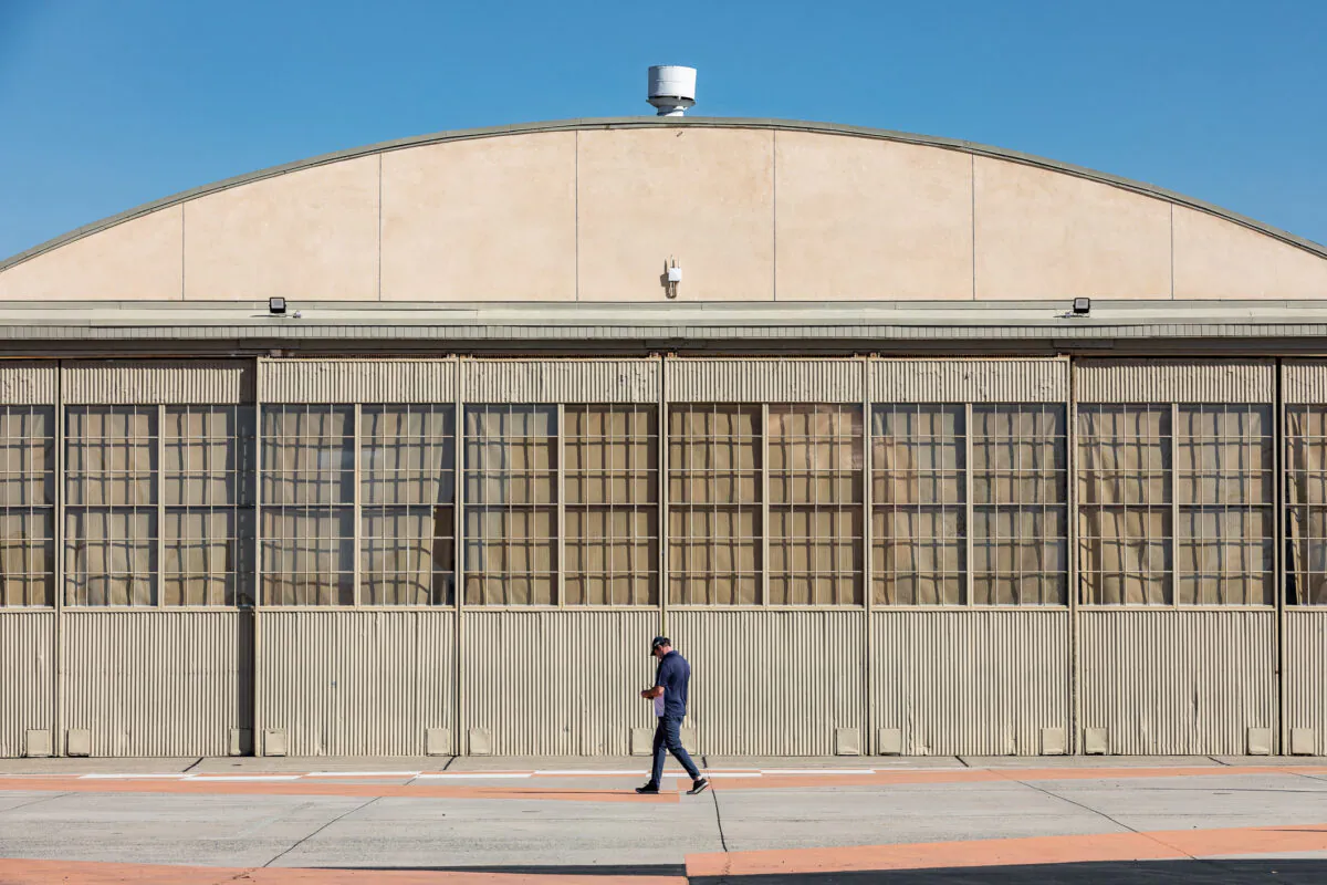 A man walks past Hangar 244 at The Orange County Great Park in Irvine, Calif., on Jan. 26, 2021. (John Fredricks/The Epoch Times)