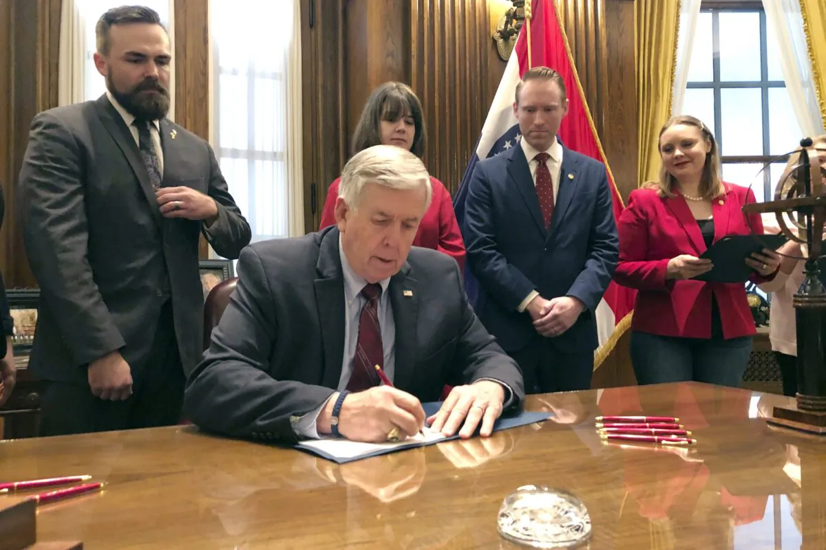 Missouri Gov. Mike Parson signs a bill banning most abortions in Jefferson City, Mo., on May 24, 2019. (Summer Balentine/AP Photo)