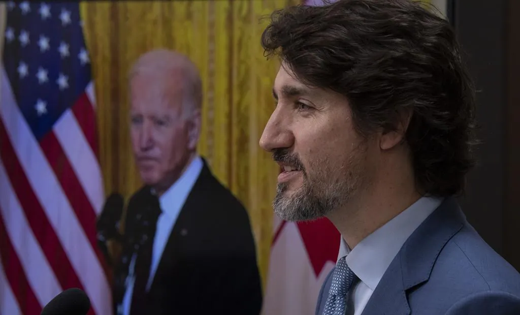 United States President Joe Biden listens as Canadian Prime Minister Justin Trudeau delivers his statement during a virtual joint statement following a virtual meeting in Ottawa, Feb. 23, 2021. (The Canadian Press/Adrian Wyld)