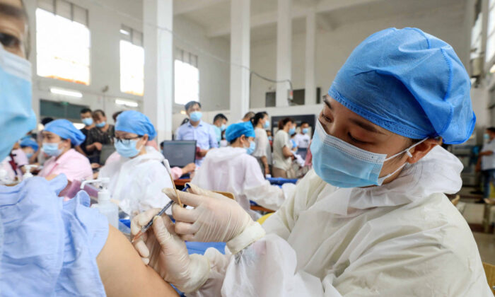A health worker administering the Sinovac COVID-19 coronavirus vaccine to a resident in Rongan in China's southern Guangxi region on June 3, 2021. (STR/AFP via Getty Images)