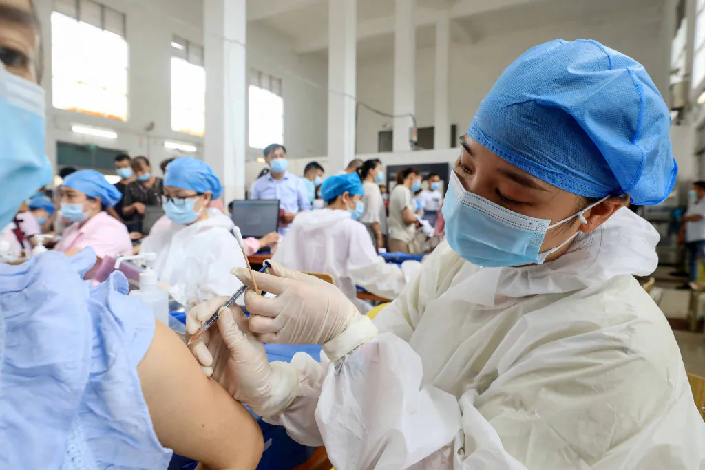 A health worker administers the Sinovac COVID-19 vaccine to a resident in Rongan, in China's southern Guangxi region on June 3, 2021. (STR/AFP via Getty Images)