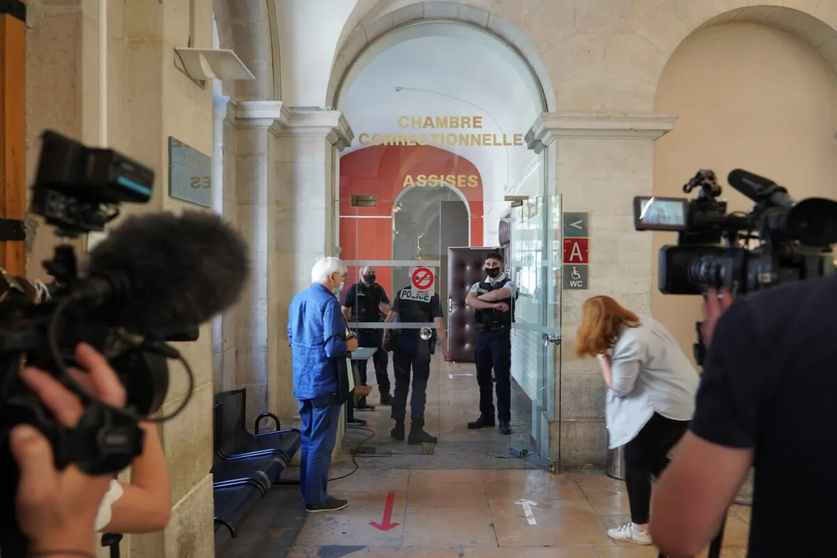 Reporters wait outside the courtroom as the 28-year-old man who slapped French President Emmanuel Macron is tried, facing possible jail time and a fine if found guilty of assaulting a public official, in Valence, central France, on June 10, 2021. (Laurent Cirpriani/AP Photo)