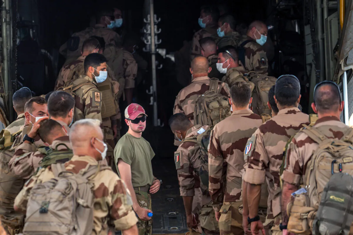 French Barkhane force soldiers who wrapped up a four-month tour of duty in the Sahel board a US Air Force C130 transport plane, leave their base in Gao, Mali, on June 9, 2021. (Jerome Delay/AP Photo)