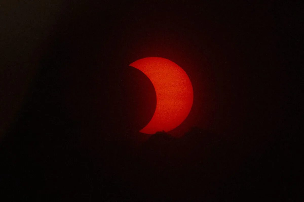 A eclipsed sun rises over New York City seen from Jersey City, N.J., on June 10, 2021. (Kena Betancur/AFP via Getty Images)