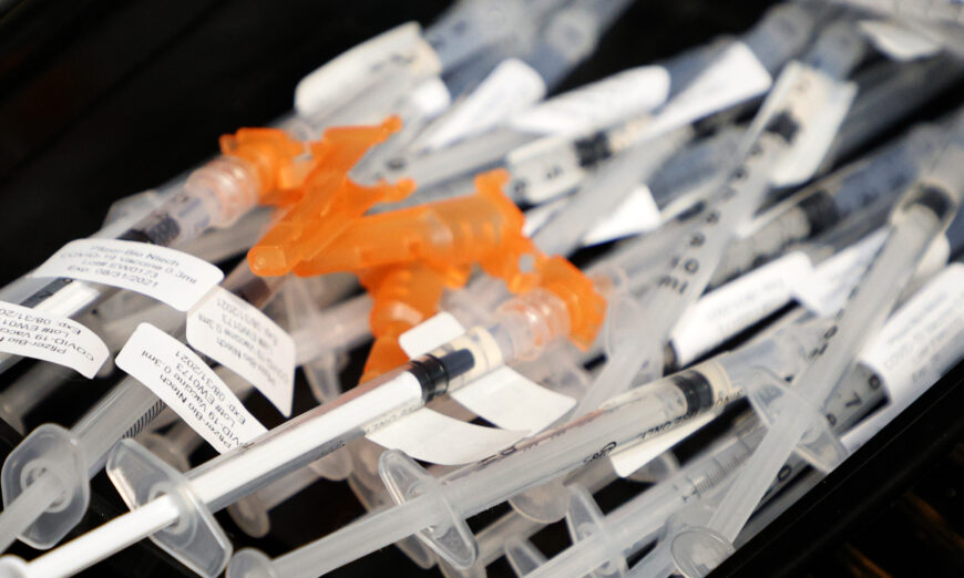 Syringes with the Pfizer-BioNTech COVID-19 vaccine are placed on a tray in Las Vegas, Nev., on May 21, 2021. (Ethan Miller/Getty Images)