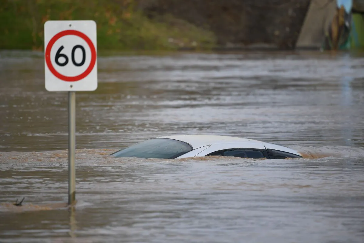 A car is seen submerged by flood water in Traralgon, Victoria, Australia on June 10, 2021. (AAP Image/James Ross)