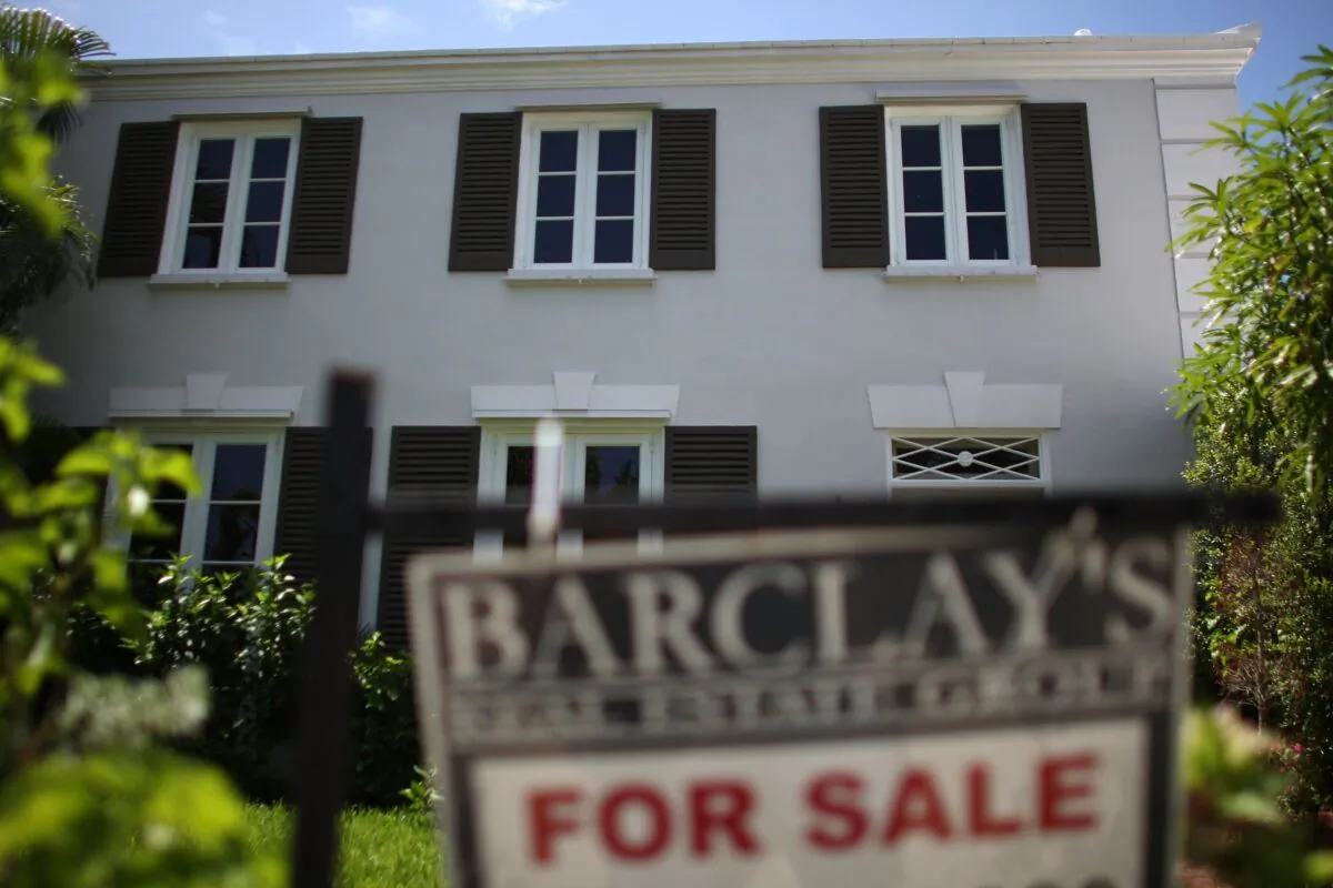 A For Sale sign is displayed in front of a home in Miami, Fla., on Aug. 10, 2007. (Joe Raedle/Getty Images)